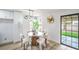 Cozy dining area with a round table, four chairs, and a view of the backyard at 10009 Coral Sands Dr, Las Vegas, NV 89117