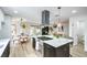 Bright modern kitchen featuring stainless steel appliances, island cooktop, and adjacent dining area at 10009 Coral Sands Dr, Las Vegas, NV 89117
