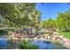 A picturesque pond with small rocky waterfalls and lush green surroundings at 10009 Coral Sands Dr, Las Vegas, NV 89117