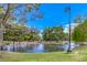 A serene pond with tall street lamp and lush green surroundings at 10009 Coral Sands Dr, Las Vegas, NV 89117