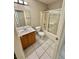 Bathroom featuring a single sink vanity and a shower over tub combo at 10025 Catseye Cove Ct, Las Vegas, NV 89183
