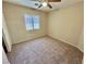Carpeted bedroom with light-colored walls, blinds on the window, and a ceiling fan at 10025 Catseye Cove Ct, Las Vegas, NV 89183
