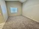 Bedroom with neutral walls, carpet flooring, and window bringing in natural light at 10025 Catseye Cove Ct, Las Vegas, NV 89183