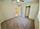 Bedroom featuring carpet, a closet, and a doorway with a light and ceiling fan at 10025 Catseye Cove Ct, Las Vegas, NV 89183