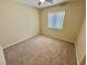 Bedroom featuring a ceiling fan, carpeted floor and a window with vertical blinds at 10025 Catseye Cove Ct, Las Vegas, NV 89183