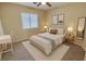 Cozy bedroom boasts natural light, carpeted floors, and neutral decor for a relaxing atmosphere at 10025 Catseye Cove Ct, Las Vegas, NV 89183
