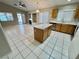 Open kitchen concept with tile flooring, kitchen island, and updated appliances at 10025 Catseye Cove Ct, Las Vegas, NV 89183