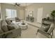 Stylish living room with neutral tones, contemporary furnishings, and bright natural lighting at 10025 Catseye Cove Ct, Las Vegas, NV 89183