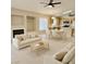 Bright living room featuring an open layout with kitchen, white couches, and tile floors at 10025 Catseye Cove Ct, Las Vegas, NV 89183