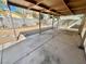 A covered patio features a concrete floor, and a gravel-landscaped yard beyond a low retaining wall and block wall at 10025 Catseye Cove Ct, Las Vegas, NV 89183