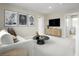 Cozy loft area featuring neutral walls, plush carpets, a comfortable sofa, and stylish decor at 10029 Luna River Ave, Las Vegas, NV 89148
