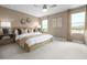 Serene primary bedroom with calm wall colors, carpet flooring, and an abundance of natural light from two windows at 10029 Luna River Ave, Las Vegas, NV 89148