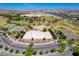 Scenic aerial shot featuring park amenities: tennis/pickleball courts, sports field, and parking, set against mountain backdrop at 1014 Solemn Cactus Ave, North Las Vegas, NV 89031
