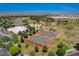 Overhead view of park with two basketball courts and sand volleyball, surrounded by green spaces and mature trees at 1014 Solemn Cactus Ave, North Las Vegas, NV 89031