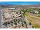 Aerial view highlighting a skate park, basketball courts, and surrounding residential areas with scenic mountain backdrop at 1014 Solemn Cactus Ave, North Las Vegas, NV 89031