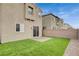 The backyard features well-maintained artificial turf, brick perimeter, and a gravel side yard at 1014 Solemn Cactus Ave, North Las Vegas, NV 89031