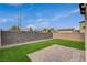 The backyard features well-maintained artificial turf, brick perimeter, and a gravel side yard at 1014 Solemn Cactus Ave, North Las Vegas, NV 89031