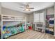 A cozy bedroom featuring a ceiling fan, playful decor, and a comfortable bunk bed at 1014 Solemn Cactus Ave, North Las Vegas, NV 89031
