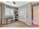 A well-lit bedroom with a large window, a ceiling fan, and closet doors with alphabet decals at 1014 Solemn Cactus Ave, North Las Vegas, NV 89031