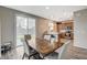 Bright dining area featuring wood-look floors, modern light fixtures, and an adjacent kitchen at 1014 Solemn Cactus Ave, North Las Vegas, NV 89031