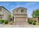 Charming two-story home with a well-maintained front yard and a two-car garage at 1014 Solemn Cactus Ave, North Las Vegas, NV 89031