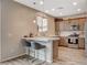 Charming kitchen featuring a breakfast bar, stainless steel appliances and stylish pendant lighting at 1014 Solemn Cactus Ave, North Las Vegas, NV 89031