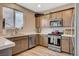 Charming kitchen with stainless appliances, a sink under a window, and abundant counter space at 1014 Solemn Cactus Ave, North Las Vegas, NV 89031