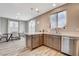 Modern kitchen and dining area with stainless steel dishwasher, stone countertops, and updated cabinetry at 1014 Solemn Cactus Ave, North Las Vegas, NV 89031