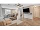 Spacious living room with modern furnishings, wood-look flooring, and a ceiling fan at 1014 Solemn Cactus Ave, North Las Vegas, NV 89031