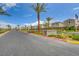 Well-maintained street with landscaped medians and palm trees, showcasing a tranquil neighborhood setting with modern homes at 1014 Solemn Cactus Ave, North Las Vegas, NV 89031
