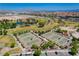 Aerial view of well-maintained community tennis courts surrounded by lush landscaping and vibrant greenery at 1014 Solemn Cactus Ave, North Las Vegas, NV 89031