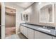 Modern bathroom with double sinks, sleek vanity, gray countertops, and tile flooring at 10166 Monks Hood Ct, Las Vegas, NV 89183
