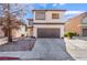 Charming two-story home with a well-maintained lawn and a spacious two-car garage at 10166 Monks Hood Ct, Las Vegas, NV 89183