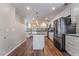 Spacious kitchen with island, stainless steel appliances, and ample cabinet storage space at 10166 Monks Hood Ct, Las Vegas, NV 89183