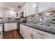 Updated kitchen featuring white cabinets, sleek countertops, and a stylish backsplash at 10166 Monks Hood Ct, Las Vegas, NV 89183