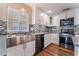 Bright kitchen showcasing a stainless steel sink, modern appliances, and mosaic tile backsplash at 10166 Monks Hood Ct, Las Vegas, NV 89183