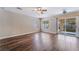 Bright living room with wood floors, backyard access, and neutral walls at 10166 Monks Hood Ct, Las Vegas, NV 89183