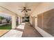 Covered patio area with ceiling fans overlooking manicured landscaping at 10166 Monks Hood Ct, Las Vegas, NV 89183