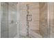 Tiled shower with glass door, built-in bench, and decorative mosaic tile accent stripe at 10166 Monks Hood Ct, Las Vegas, NV 89183