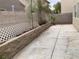 Concrete backyard with a low garden box, block wall, and some landscaping at 10238 Missouri Meadows St, Las Vegas, NV 89183
