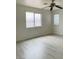 Bright bedroom with light wood-look flooring, large windows and a ceiling fan at 10238 Missouri Meadows St, Las Vegas, NV 89183