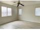 Bright bedroom with light wood-look flooring and three windows at 10238 Missouri Meadows St, Las Vegas, NV 89183