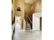 Inviting entryway featuring a staircase and a bright, airy feel with hardwood style flooring at 10238 Missouri Meadows St, Las Vegas, NV 89183
