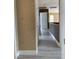 Bright hallway with white trim and wood-look floors leads to an open doorway at 10238 Missouri Meadows St, Las Vegas, NV 89183