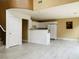 Open kitchen area featuring white cabinetry, breakfast bar, and a view of the living area at 10238 Missouri Meadows St, Las Vegas, NV 89183