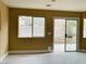 Bright living room with sliding glass doors opening to a private outdoor space and views from the window at 10238 Missouri Meadows St, Las Vegas, NV 89183