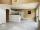 Open-concept living space with a kitchen featuring white appliances and a breakfast bar at 10238 Missouri Meadows St, Las Vegas, NV 89183