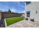 Backyard with an area of green lawn, patio and desert landscaping at 10273 Fragrant Apple Ct, Las Vegas, NV 89141