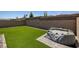 Artificial turf surrounds an inflatable jacuzzi in this outdoor space at 10273 Fragrant Apple Ct, Las Vegas, NV 89141