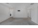 Large bedroom featuring gray carpet flooring, white walls, and multiple doorways at 10273 Fragrant Apple Ct, Las Vegas, NV 89141